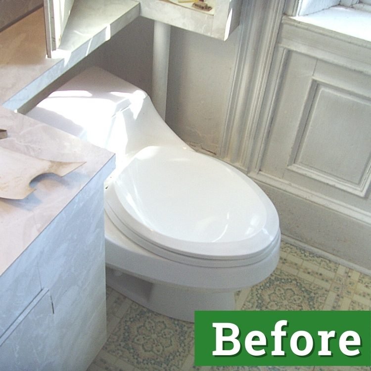 a white toilet in a bathroom in need of repair