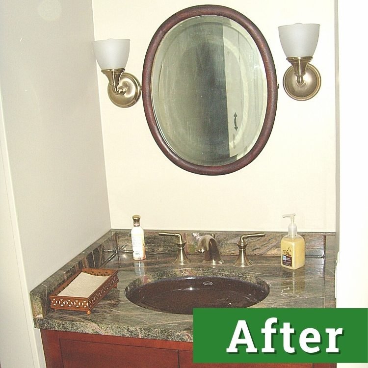 a renovated bathroom with dark oak accents and cabinetry