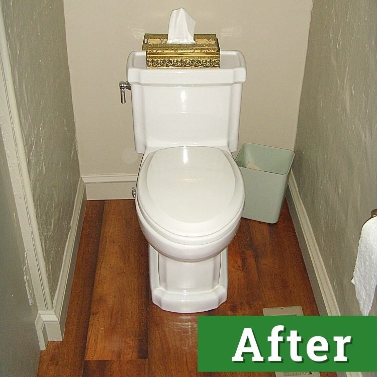 a newly installed white toilet on hard wood flooring