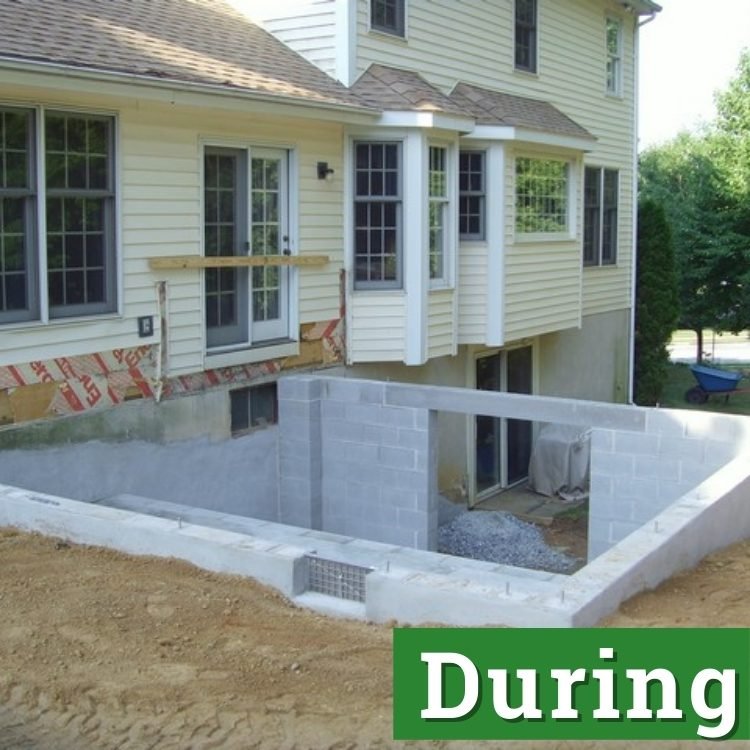 a newly built foundation with a basement made of grey construction bricks and cement