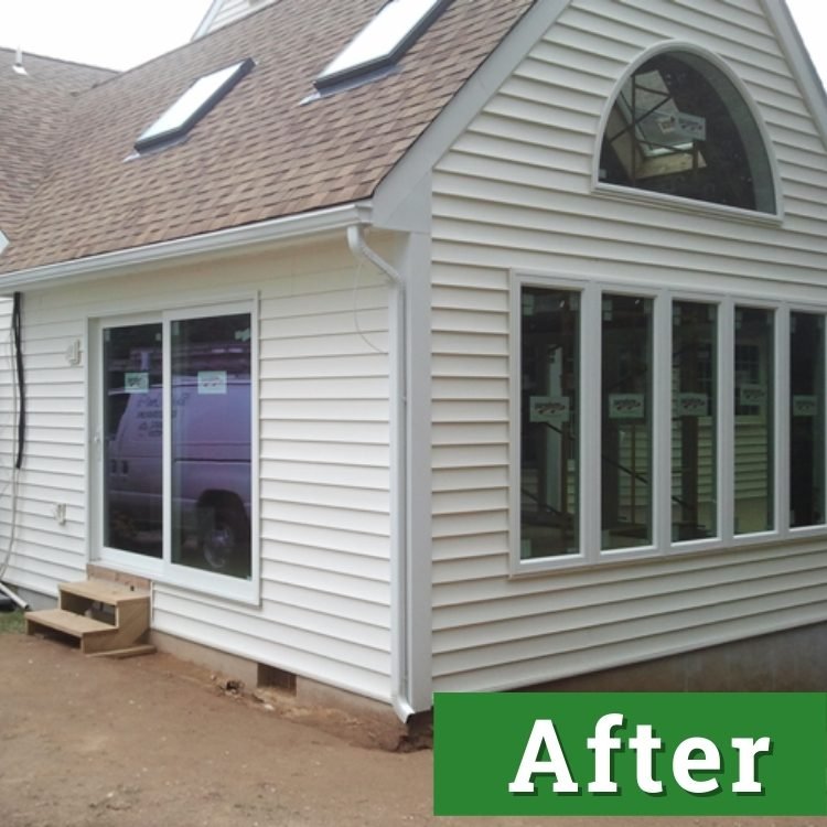 new windows and sliding glass doors of a new sunroom addition