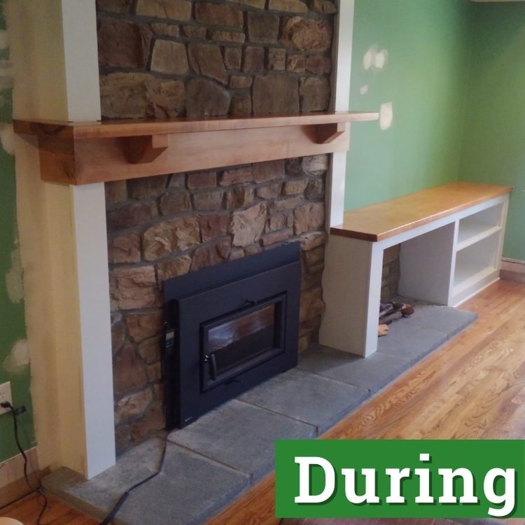 a stone fireplace with a custom built wooden mantel