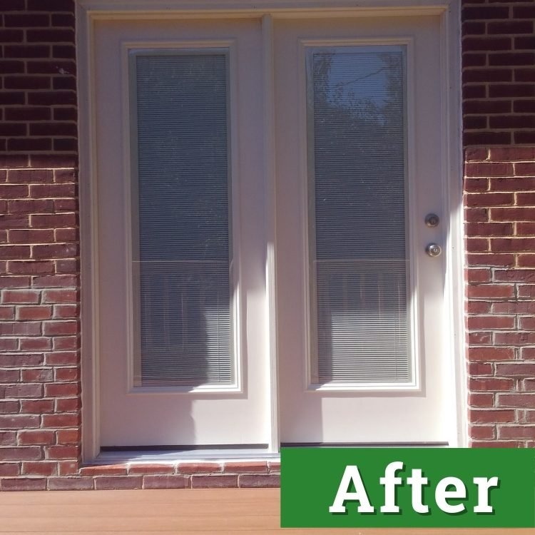 white double doors on a brick home