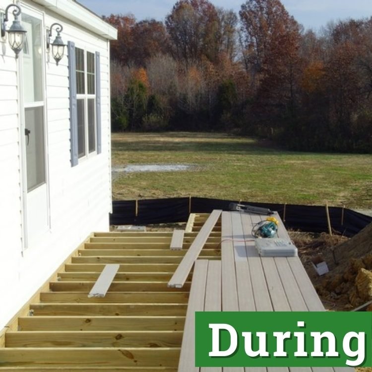 an unfinished deck attached to a white house