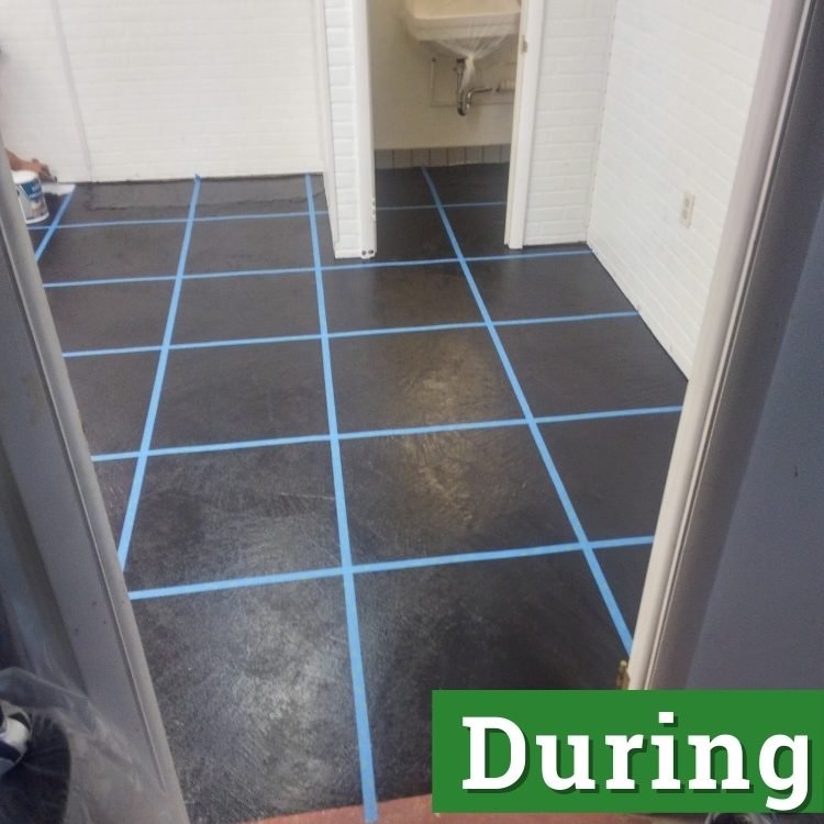 blue tape crisscrosses over a black floor
