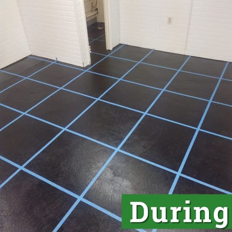 a black floor with blue tape in marking a grid