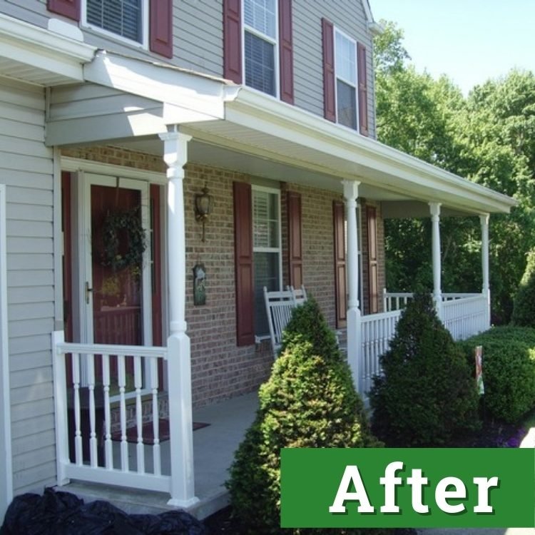 a newly installed front porch with white railings behind green shrubbery