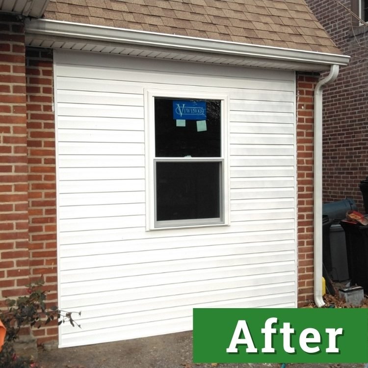 white siding and a window of a converted garage