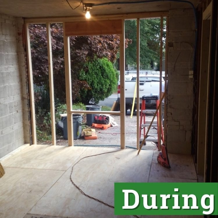 plywood flooring and beams in an unfinished converted garage