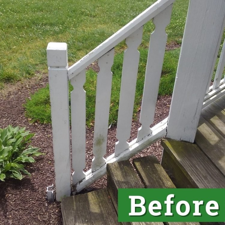 a white railing with mold stained slats