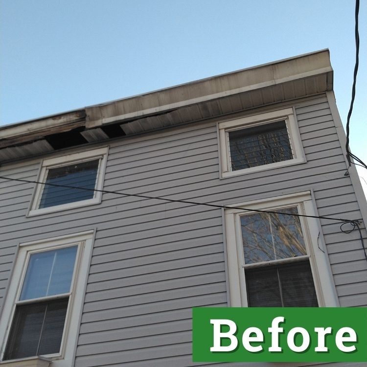 gutter damage on a light gray house