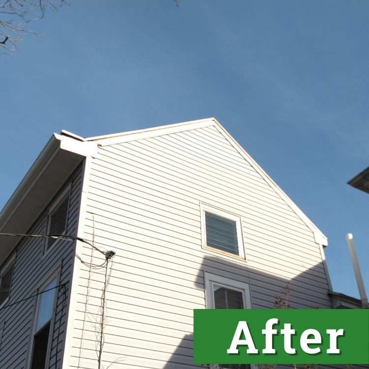 new siding near the roof of a light gray house