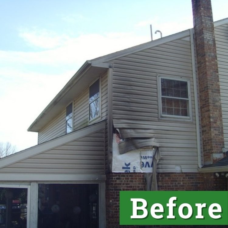 damaged siding due to an electrical problem hangs from the side of a beige house