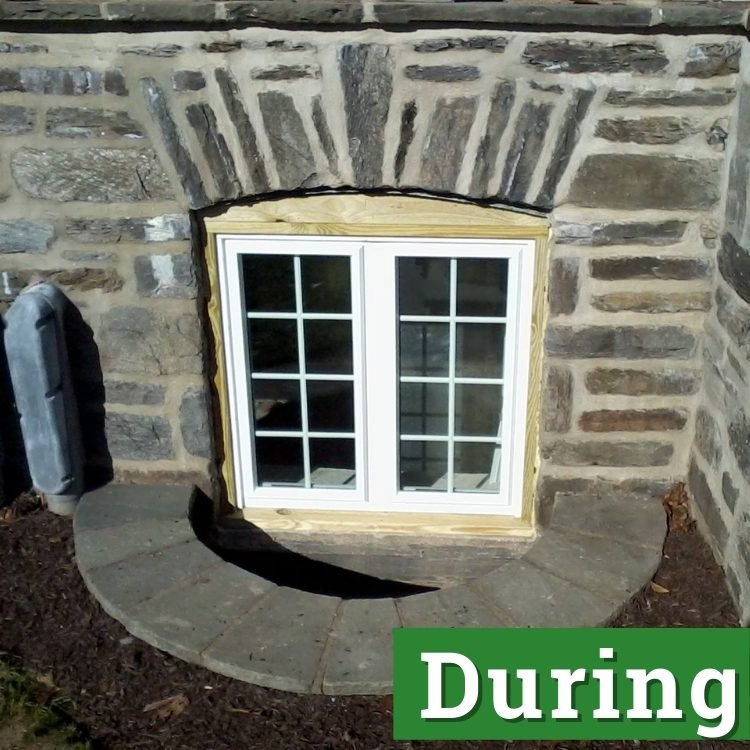 a basement egress window under construction